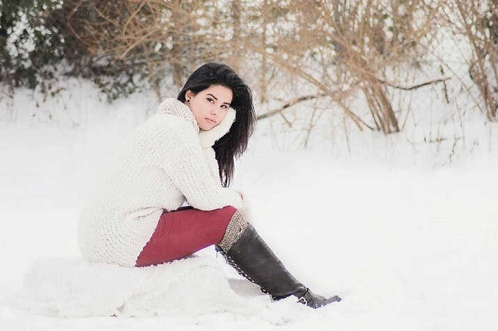 a woman sitting on the snow